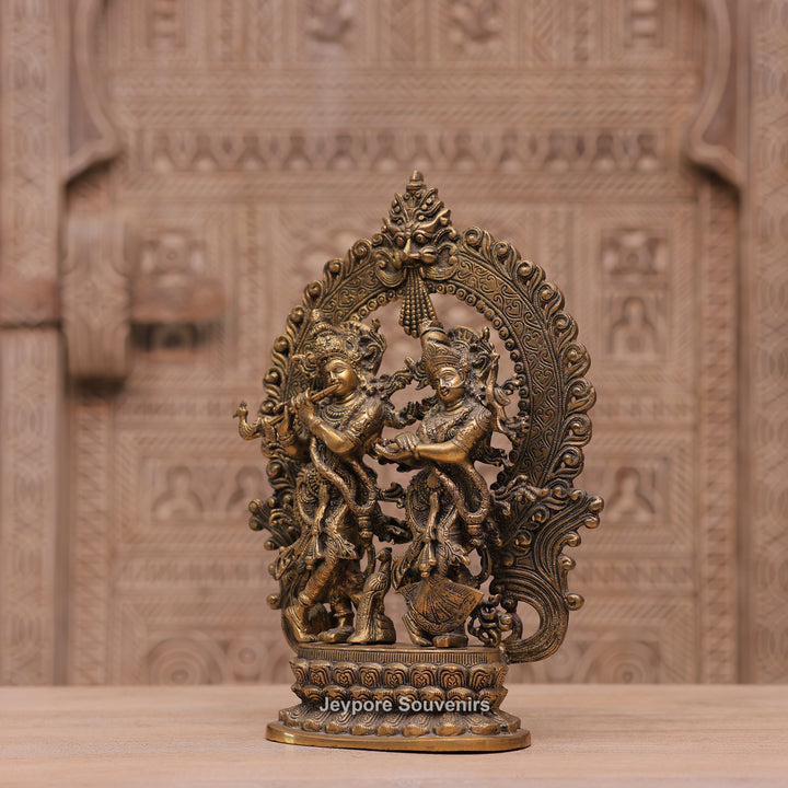 Handcrafted Brass Radha Krishna Statue with Ornamental Prabhavali Arch
