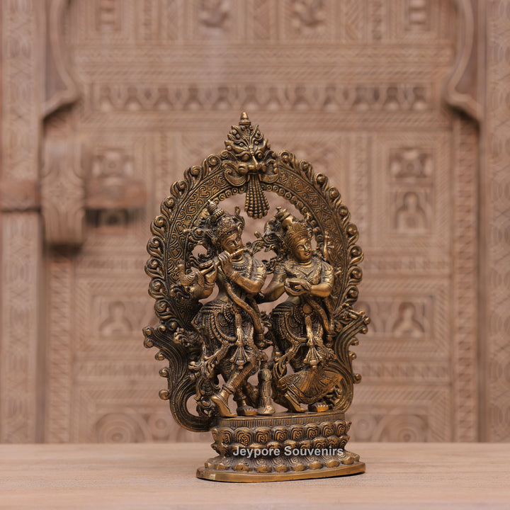Handcrafted Brass Radha Krishna Statue with Ornamental Prabhavali Arch